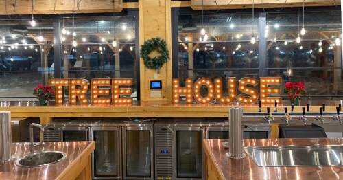 Bar with the word "Tree House" behind it with holiday setting
