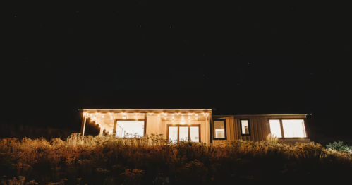 A vacation rental in Chelan, Washington, is lit up under a dark sky.