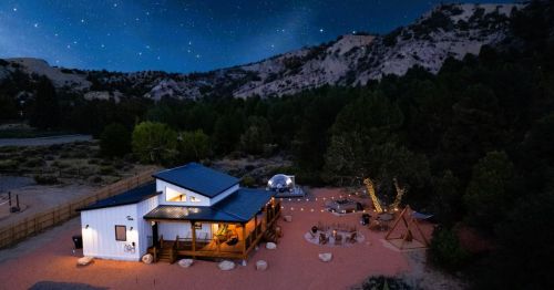 A stargazing Airbnb with a geodesic dome in Utah, surrounded by rolling hills under a night sky.
