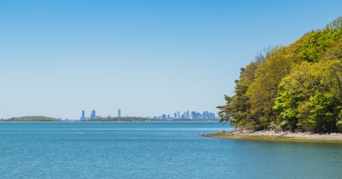views of boston in the distance as seen from world's end, a park in hingham massachusetts on a sunny day