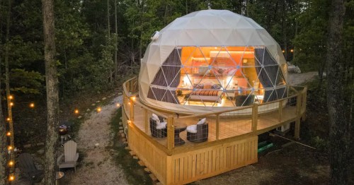 White and clear dome on a wooden platform under twinkle lights