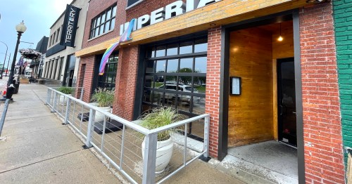 Businesses line a street under a gray sky in Ferndale, Michigan.