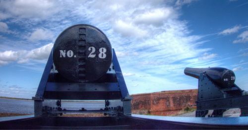 Two large cannons at Fort Clinch State Park in Florida, underneath gloomy skies.