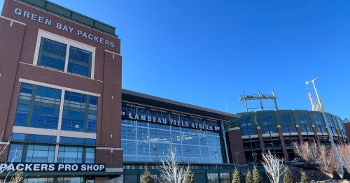 Red brick and green accented exterior of Lambeau Field.