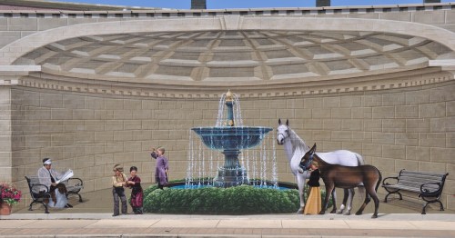 A colorful mural depicts children playing near a fountain while a woman in a yellow skirt holds the reins of a white horse and a brown mule.