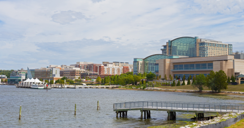 view of the national harbor and its pier as seen from a beach in oxon hill md
