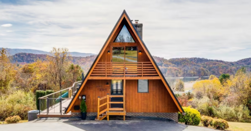 An A-Frame cabin in Virginia overlooking the mountains and a lake.