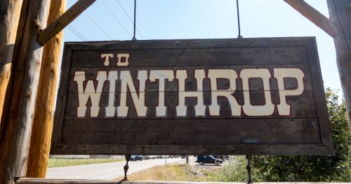 A dark brown wooden sign that says "To Winthrop" in white lettering