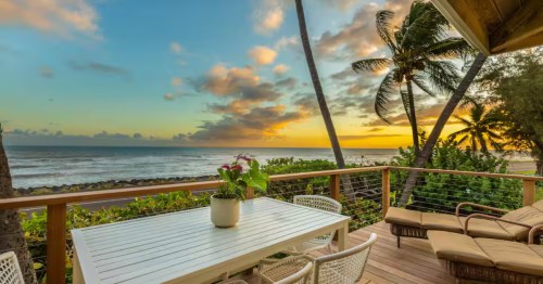 A Hawaiian lanai overlooks a sunset in Hawaii.