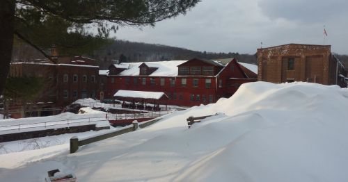A charming New England town with a red building.