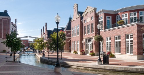 Historic brick buildings line a canal.