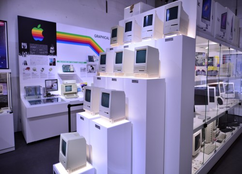 Interior of the Apple Museum featuring a pyramid display of vintage Macintosh computers arranged in a striking installation.