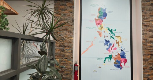 An indoor wall featuring a large poster with a picture of the Philippines.
