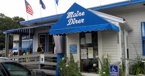 The exterior of a blue-and-white diner reading "Maine Diner" on the awning.