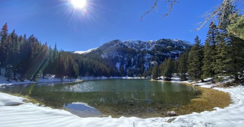 Blue skies are open and bright on a winter's day above Middle Fork Lake on the Middle Fork Lake Trail near Taos, New Mexico.