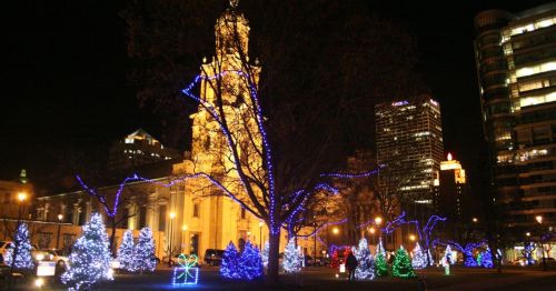 A festive holiday lights display in a park.