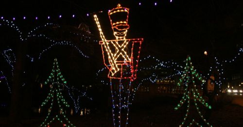 A holiday lights display in the shapes of Christmas trees and a nutcracker.