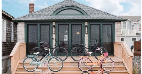 Photo of a beautiful beach bungalow in Point Pleasant Beach, NJ with several colorful bikes, parked on the front steps.