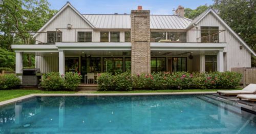 Exterior of a vacation rental property in Montauk, New York, with a gorgeous infinity pool and beautiful landscaping.