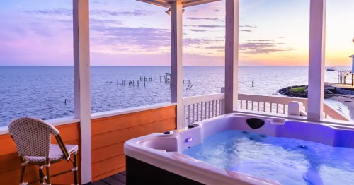 A view from the jacuzzi overlooking the water as the sun sets.