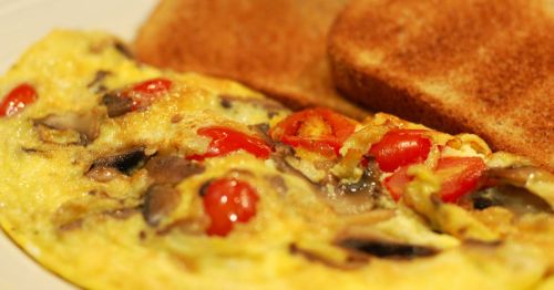A closeup of an omelette and two slices of toast.