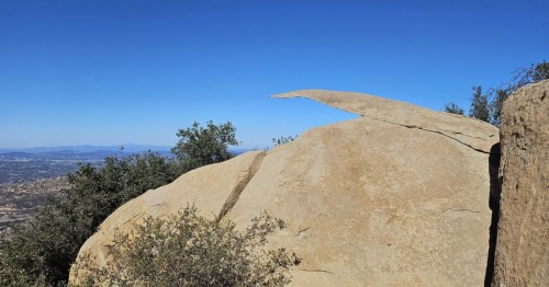 A view of the unique rock formation, Potato Chip Rock, on a blue-sky day in Southern California.