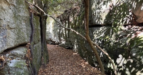 A narrow maze made of boulders with pathways between them.