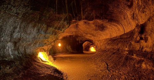 Lights hang on the side of the Thurston Lava Tube's interior.