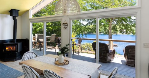 Airbnb with large windows overlooking a lake in New Hampshire