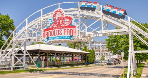 Entrance sign at Arnolds Park Amusement Park in Iowa, a popular yet overhyped Midwest tourist destination known for its vintage rides and lakeside boardwalk.