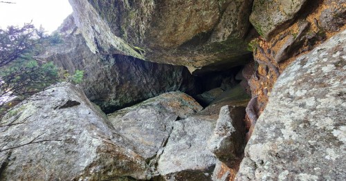 A narrow chasm opening into a rock wall.