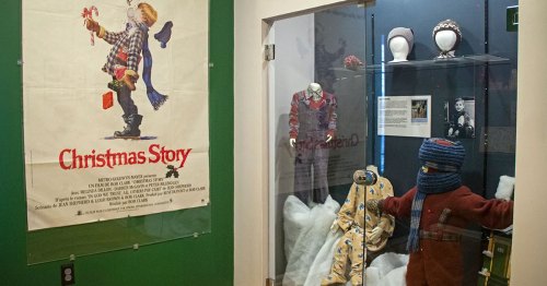Movie props stand in a glass museum case.