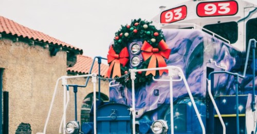 front of the sly railway christmas teain decorated wth a christmas wreath