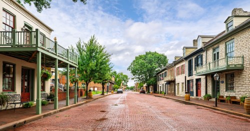 Picturesque brick street lined with historic buildings in St. Charles, Missouri, capturing the timeless small-town charm perfect for a Hallmark movie setting.
