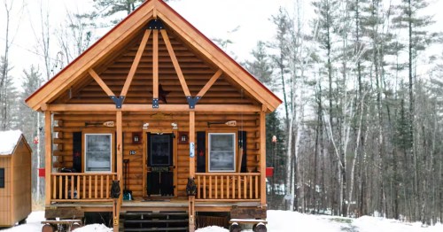Snowy log cabin exterior in New Hampshire