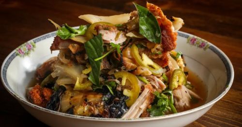 A creative dish piled high with a combination of meat and multicolor vegetables, served at The Katherine, a unique restaurant in Florida.