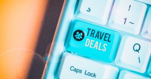 A keyboard with a button for Travel Deals highlighted in blue on an orange background.