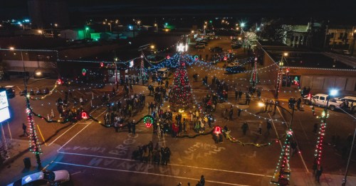 aerial shot of downtown wakeeney kansas with its large decorated tree and strings of lights at night