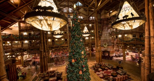 Tall green Christmas tree with colorful bauble ornaments in the lobby of the Wilderness Lodge.