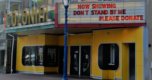 Exterior of the historic Colonial Theatre in Phoenixville, featuring its yellow facade and retro marquee.