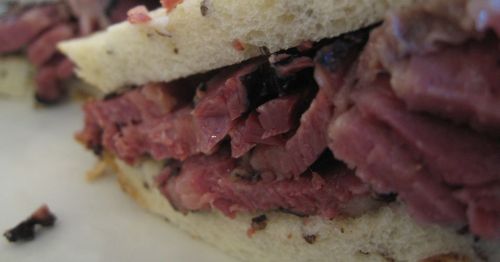 A close-up of a Pastrami sandwich.
