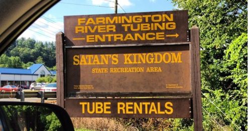A wooden sign for a river tubing business.