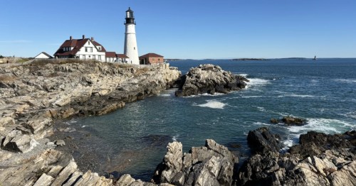 Portland Head Light lighthouse stands on the rocky coast, viewed along the scenic Fort Williams Park Loop.