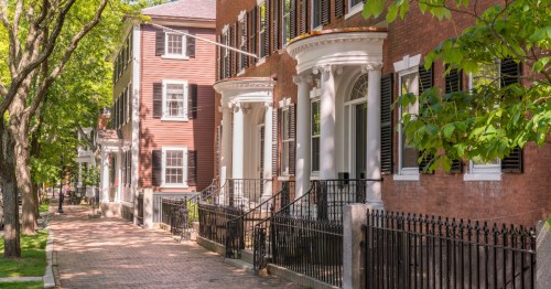 Historic brick homes line a street in Salem, Massachusetts.
