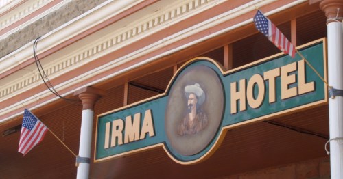 A close-up of the Irma Hotel sign that hangs on the exterior of the building in Cody, Wyoming.