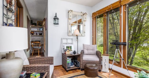 A sitting area with oversized picture windows and white walls