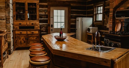 Dark toned bar area with leather round stools