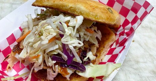 A massive deli sandwich overflowing with fresh veggies served at TJ's Sandwich Shop in Fayetteville, Arkansas
