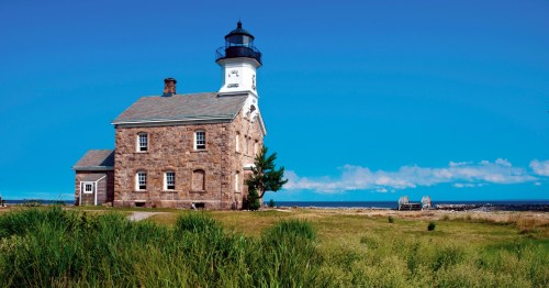 the sheffield lighthouse under a bright blue sky in norwalk ct