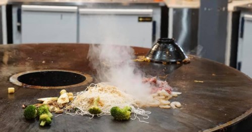 a large griddle with an upside down bowl and food cooking at buffettime in New Mexico